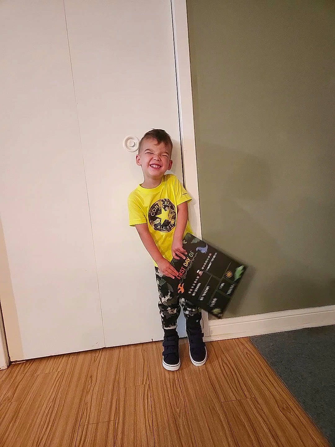 Remington joined the competition — help win amazing prizes! boot, child, door, floor, flooring, fun, happy, hardwood, human_leg, joy, knee, laminate_flooring, pattern, person, sleeve, smile, t_shirt, toddler, varnish, wood