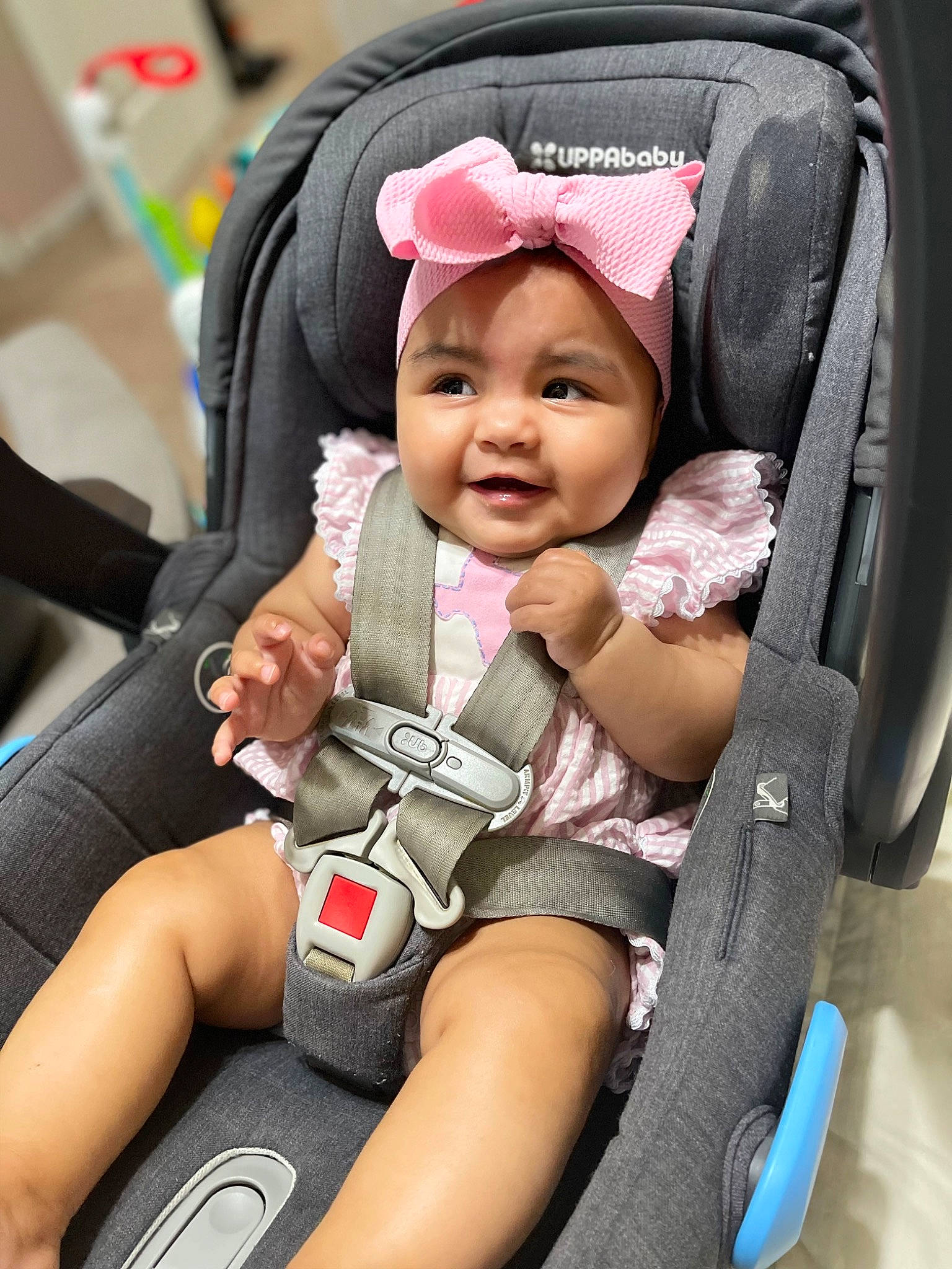 Giana is registered to the contest to win money with this photo: arm, auto_part, baby, baby_carriage, baby_products, baby_safety, baby_toddler_clothing, car_seat, child, comfort, fun, happy, hat, headwear, person, product, seat_belt, service, sitting, smile