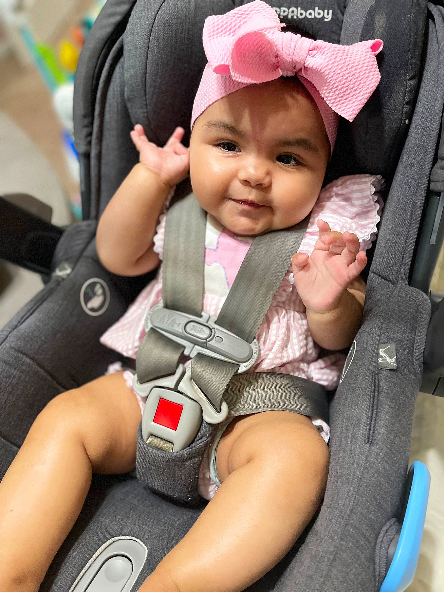 Giana is registered to the contest to win money with this photo: arm, baby, baby_in_car_seat, baby_toddler_clothing, cap, car_seat, child, comfort, finger, gesture, hand, happy, headwear, people, person, photograph, product, seat_belt, skin, smile