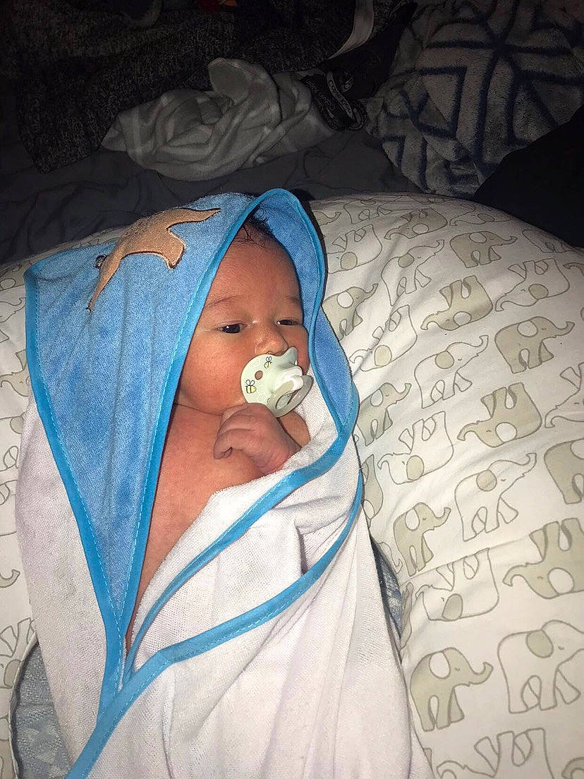 Korbyn is registered to the contest to win money with this photo: baby, baby_products, baby_safety, bedding, bedtime, cheek, child, comfort, electric_blue, event, eyebrow, hat, head, linens, mouth, nap, person, room, sleep, textile