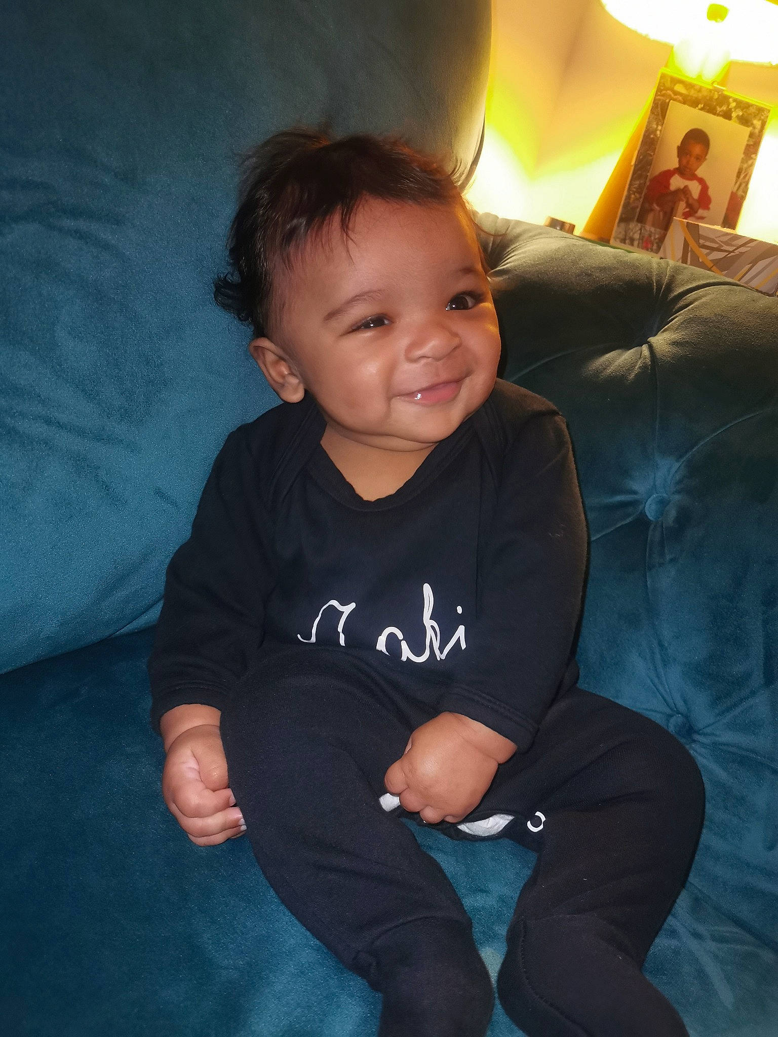 Zaki is registered to the contest to win money with this photo: baby_toddler_clothing, cheek, comfort, couch, elbow, eye, finger, flash_photography, fun, happy, head, human_body, iris, joy, lap, leg, person, shoulder, skin, sleeve