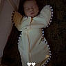 baby, sleeping, crib, blanket, swaddle, infant, indoor, cozy, heart_emoji, child, soft_lighting, face, cute, resting, person, newborn, text_overlay, striped, comfort, quiet