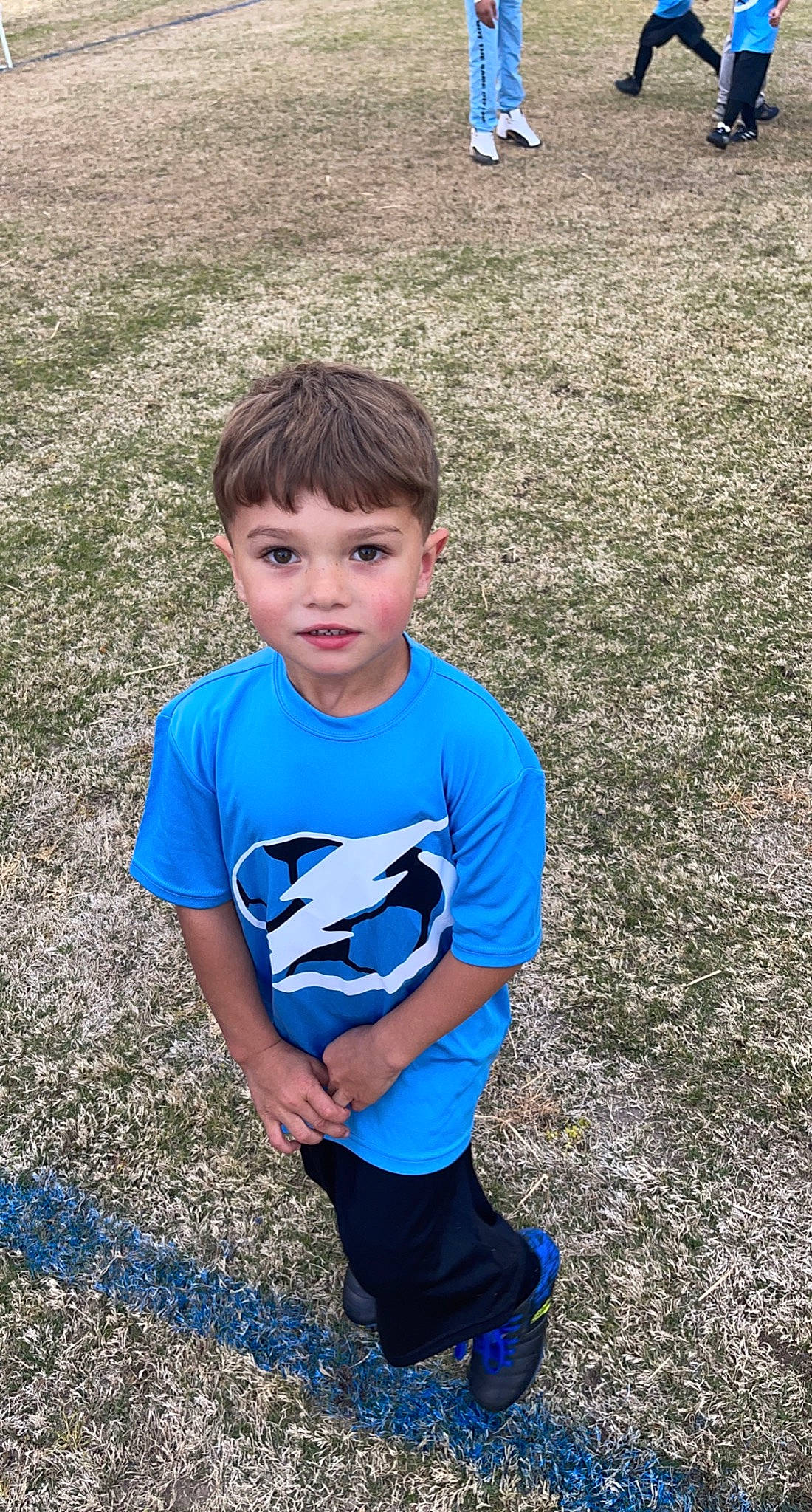 Hunter is registered to the contest to win money with this photo: child, chin, cool, electric_blue, face, fun, grass, grass_family, grassland, hair, hairstyle, happy, head, leisure, people_in_nature, person, plant, recreation, sleeve, t_shirt