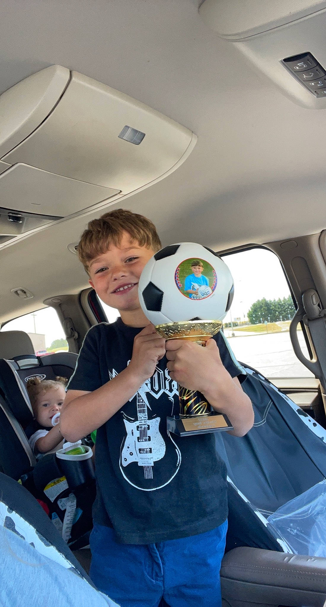 Hunter is registered to the contest to win money with this photo: auto_part, automotive_design, automotive_exterior, automotive_window_part, electric_blue, family_car, fun, gesture, joy, leisure, luxury_vehicle, motor_vehicle, person, personal_protective_equipment, recreation, shirt, smile, steering_wheel, t_shirt, vehicle