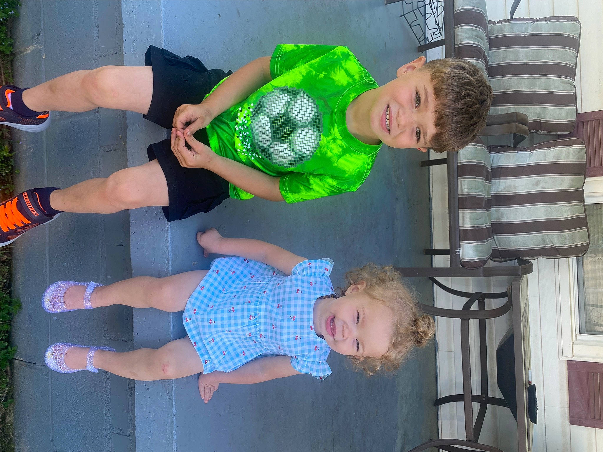 Hunter is registered to the contest to win money with this photo: arm, baby, baby_toddler_clothing, child, electric_blue, event, fun, gesture, green, happy, human_leg, joy, leisure, organ, person, plant, shorts, stool, t_shirt, thigh