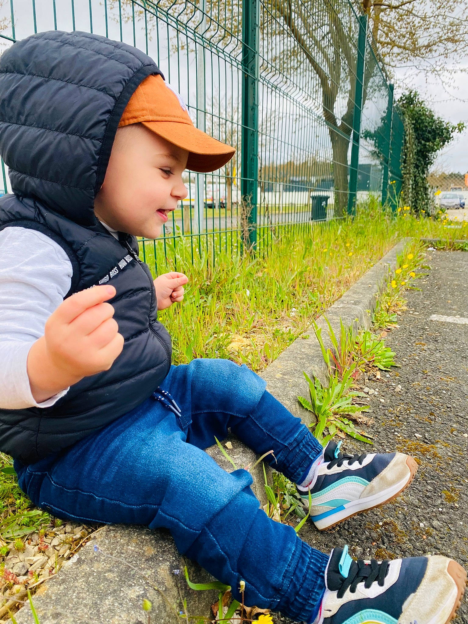 Braydon participe au concours pour gagner de l'argent avec cette photo : asphalt, cap, clothing, cool, denim, fence, grass, hat, headwear, jeans, leaf, leisure, people_in_nature, person, photograph, plant, shoe, smile, sneakers, street_fashion