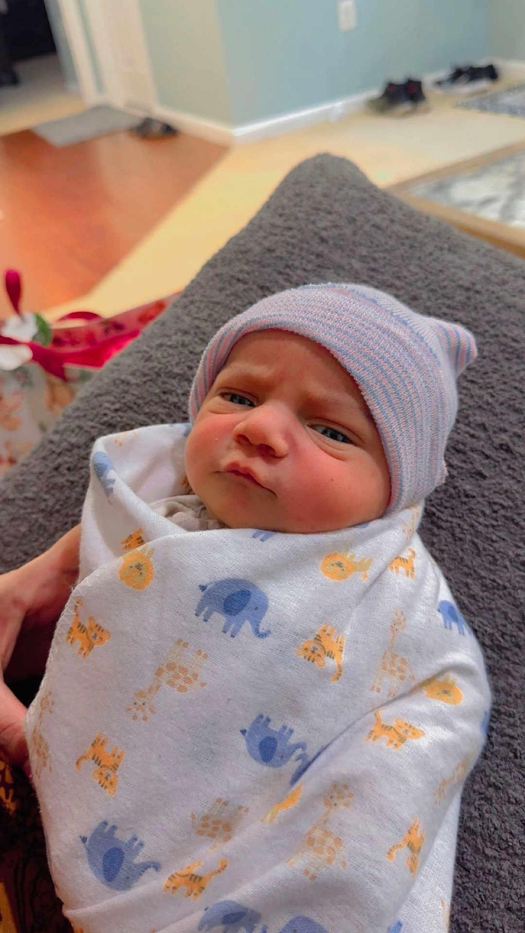 Rahim joined the competition — help win amazing prizes! baby, newborn, blanket, beanie, wrapped, indoor, cozy, animal_print, expression, face, person, child, soft_lighting, resting, hand, fabric, cute, portrait, human, infant