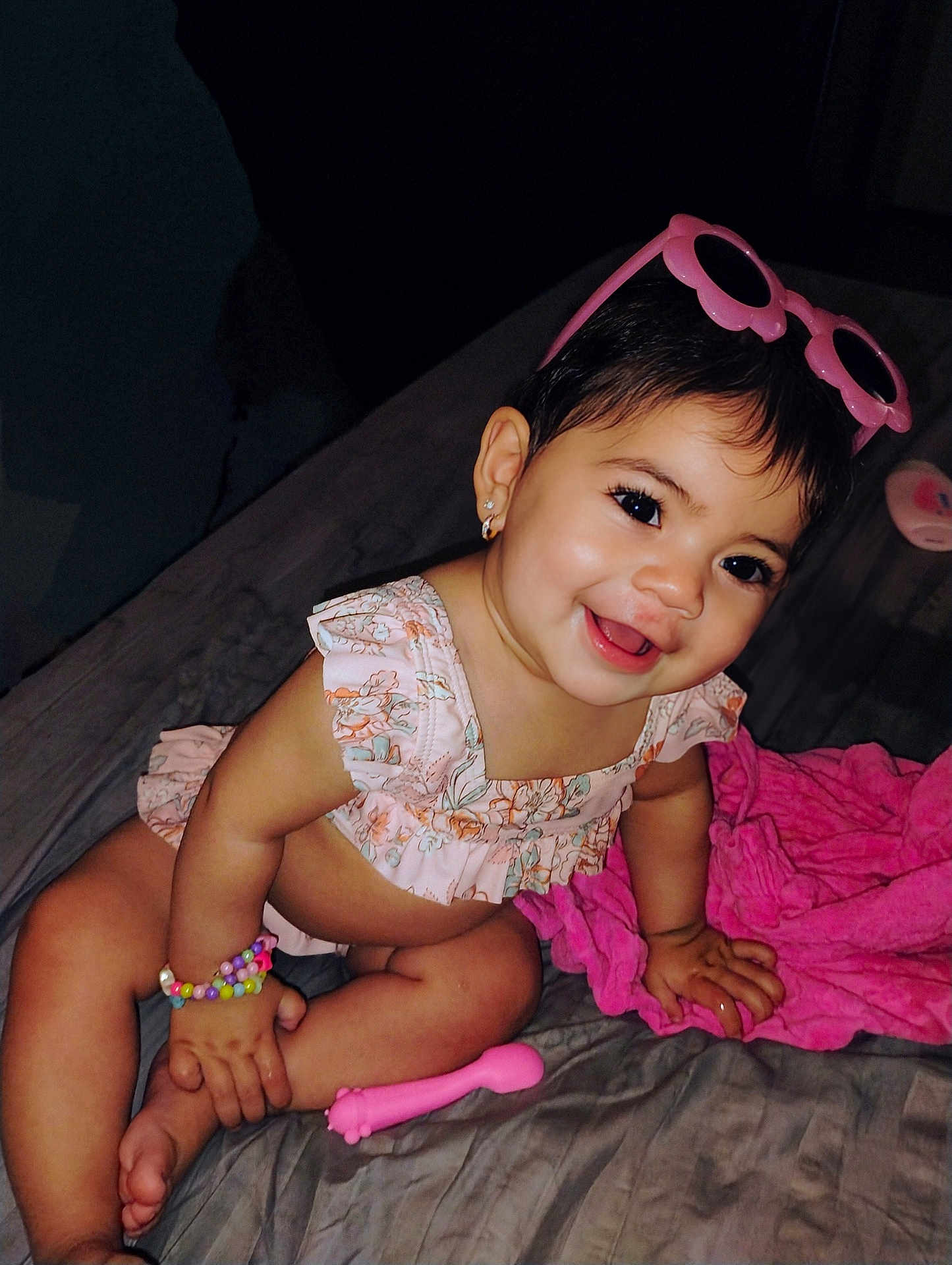 Penelope joined the competition — help win amazing prizes! baby, child, smiling, sunglasses, bracelet, bed, blanket, happy, cute, pink, clothing, person, portrait, infant, accessory, jewelry, indoor, skin, face, toddler