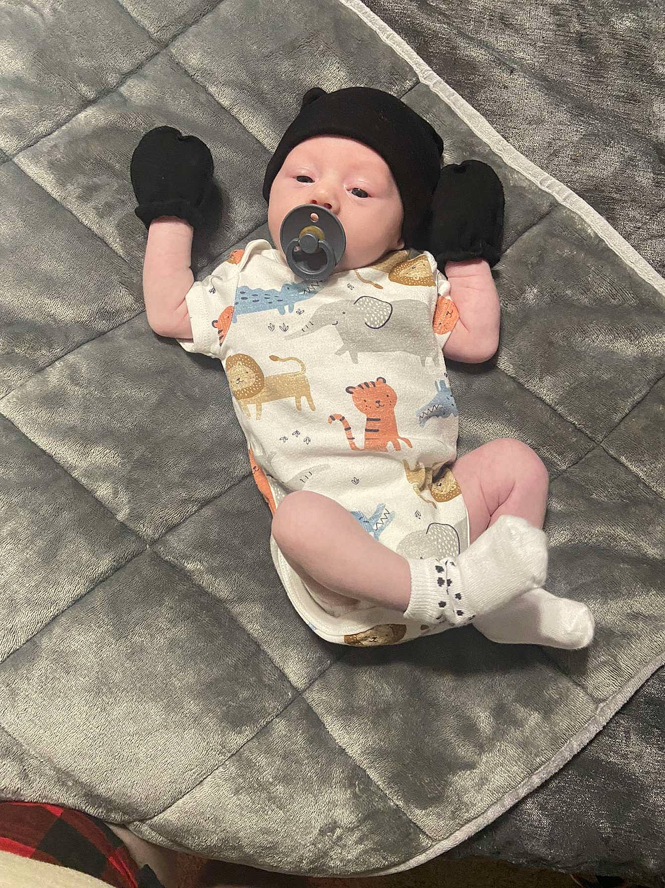 Ryatt joined the competition — help win amazing prizes! baby, baby_products, baby_toddler_clothing, cap, child, comfort, doll, fedora, foot, headwear, human_leg, lap, leg, pattern, person, personal_protective_equipment, sitting, skin, sun_hat, thigh