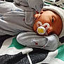 Michael is registered to the contest to win money with this photo: newborn, baby, pacifier, onesie, hat, blanket, sleeping, infant, bed, patterned_clothing, closeup, face, resting, soft, cute, child, human, portrait, comfort, indoors