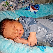 Michael is registered to the contest to win money with this photo: newborn, baby, sleeping, pajamas, blue, infant, cozy, soft, blanket, baby_nest, shark_pattern, hand, face, peaceful, indoors, child, cute, resting, toddler, closeup