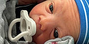 Ezra is registered to the contest to win money with this photo: baby, blanket, blue, child, closeup, comfort, cozy, cute, eyes, face, hat, indoors, infant, newborn, pacifier, portrait, skin, soft, striped, wrapped