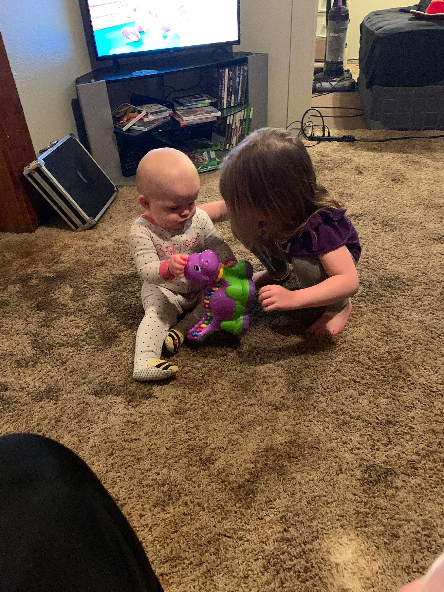 Channing joined the competition — help win amazing prizes! carpet, child, electronic_device, floor, flooring, fun, gadget, interaction, leg, person, play, room, sitting, technology, toddler