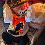 baby, infant, sleeping, turkey_hat, thanksgiving, pacifier, mickey_mouse, orange_bow, white_shirt, black_pants, blanket, cushion, feet, hands, cozy, indoors, cute, holiday, child, soft_lighting