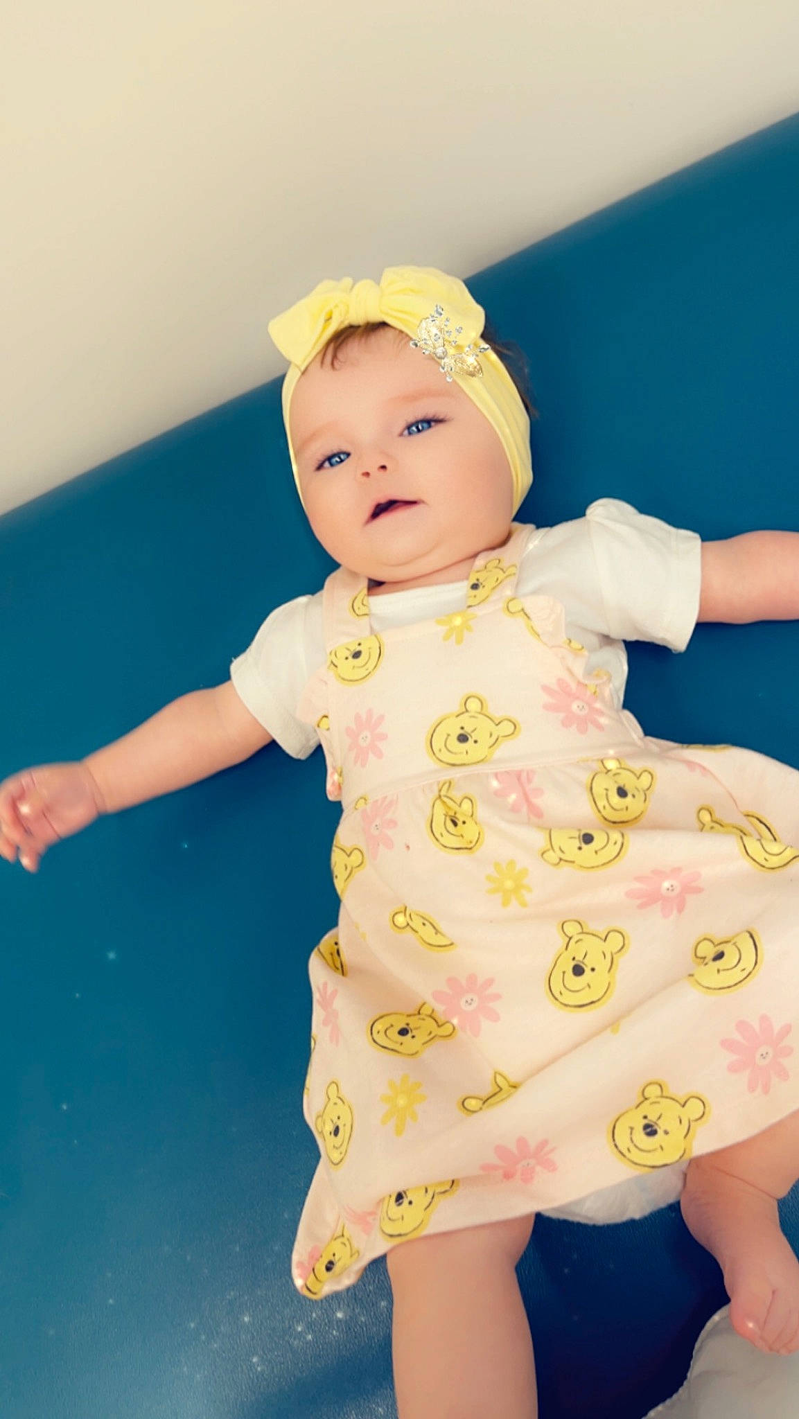 Kyra is registered to the contest to win money with this photo: baby, baby_toddler_clothing, cheek, child, day_dress, dress, face, fun, happy, head, human_body, magenta, one_piece_garment, pattern, peach, person, pink, play, skin, sleeve