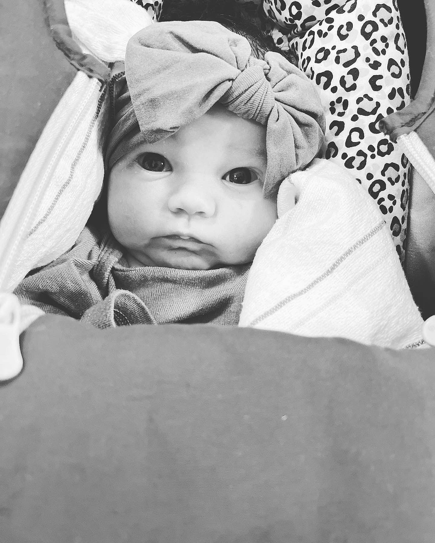 Kyra is registered to the contest to win money with this photo: baby, black_and_white, costume_hat, eyebrow, fashion_accessory, flash_photography, fun, fur, grass, happy, headpiece, headwear, monochrome, monochrome_photography, person, room, sitting, smile, stock_photography, style