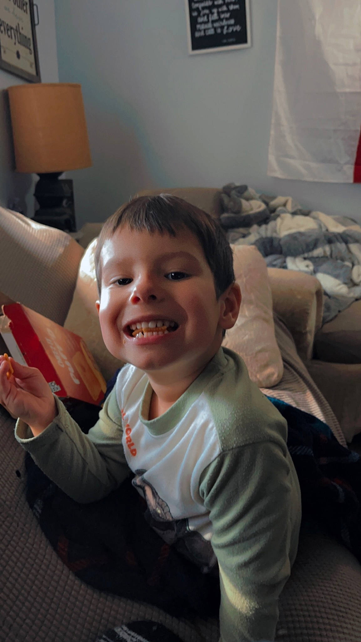 Koda is registered to the contest to win money with this photo: baby, child, comfort, electronic_device, finger, flooring, fun, gesture, happy, joy, lamp, living_room, mouth, person, room, sitting, skin, smile, t_shirt, thumb