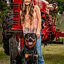 Atlas is registered to the contest to win money with this photo: woman, dog, rottweiler, tractor, outdoor, grass, smiling, animal, pet, jeans, pink_top, boots, nature, farm, vehicle, portrait, happy, canine, summer, vintage