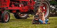 Atlas joined the competition — help win amazing prizes! woman, dog, rottweiler, tractor, farmall, grass, outdoor, smiling, vintage, red, jeans, boots, nature, animal, pet, portrait, rural, summer, happy, leisure