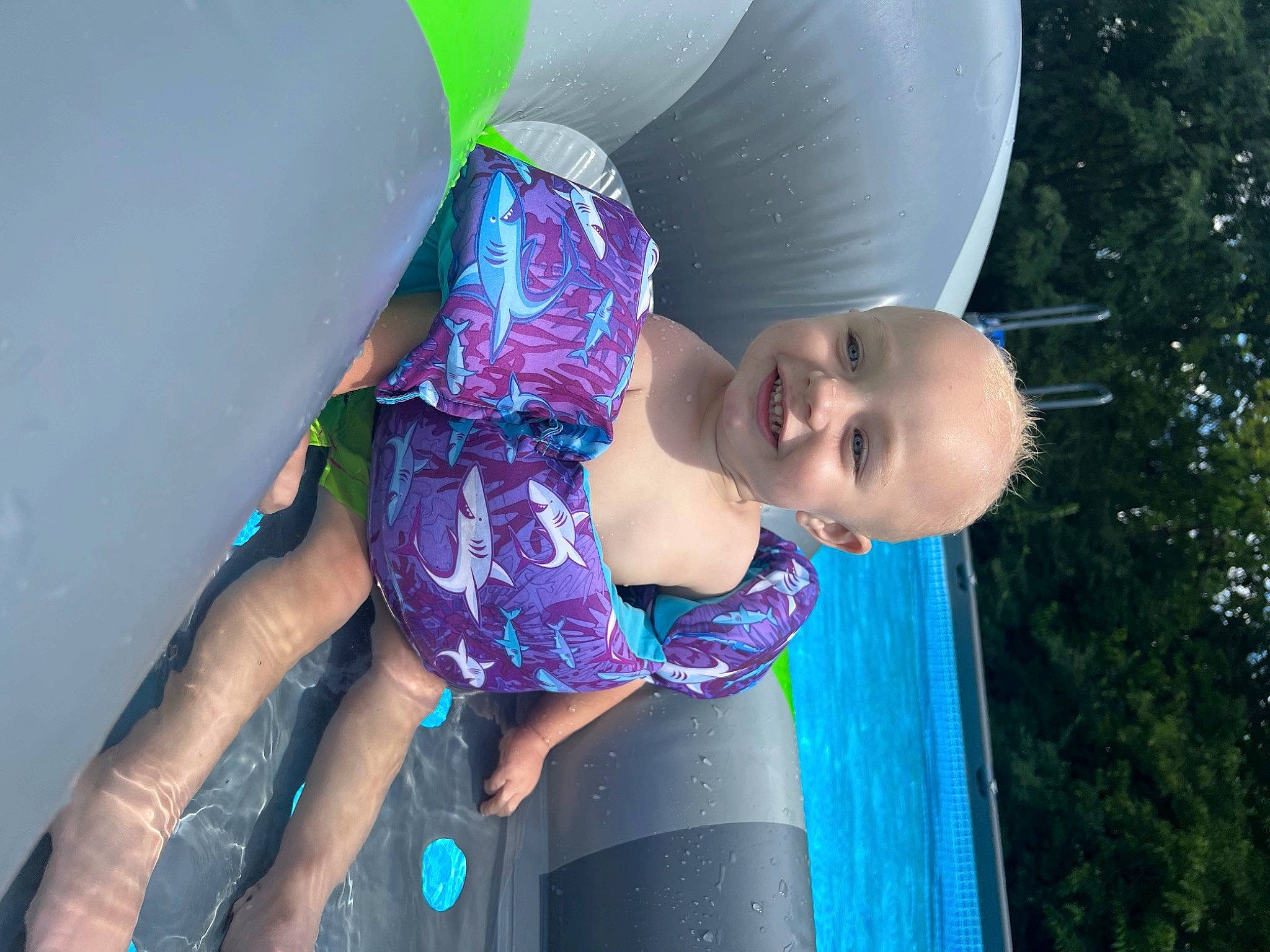 Grayson is registered to the contest to win money with this photo: baby, baby_toddler_clothing, child, electric_blue, fun, grass, happy, hat, human_body, joy, leisure, magenta, pattern, person, pink, purple, recreation, sitting, smile, toddler