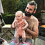 Jeanne a rejoint le concours — aidez-le/la à gagner de superbes lots ! baby, man, outdoor, beard, shirtless, child, smiling, greenery, wooden_chair, table, food, phone, summer, casual, nature, patio, plants, happy, person, relaxing