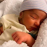 Hans is registered to the contest to win money with this photo: baby, newborn, sleeping, blanket, hat, infant, cute, soft, cozy, child, peaceful, rest, closeup, warm, tiny, hand, face, portrait, indoors, comfort