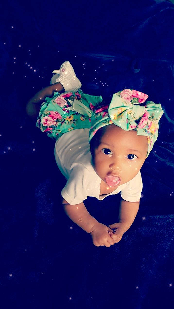 Kaziah is registered to the contest to win money with this photo: baby, baby_toddler_clothing, bonnet, child_model, costume, costume_accessory, costume_hat, cut_flowers, embellishment, fictional_character, flash_photography, hair_accessory, headband, headgear, headpiece, headwear, party_supply, person, portrait_photography, space