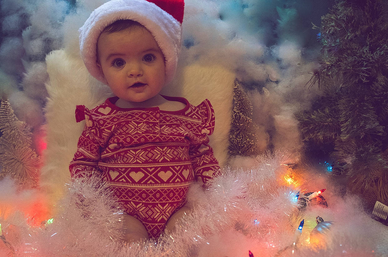 Isabel is registered to the contest to win money with this photo: art, baby, beauty, child, christmas_ornament, event, eye, fun, happy, holiday, human, light, magenta, people, people_in_nature, person, pink, sky, toddler, tradition