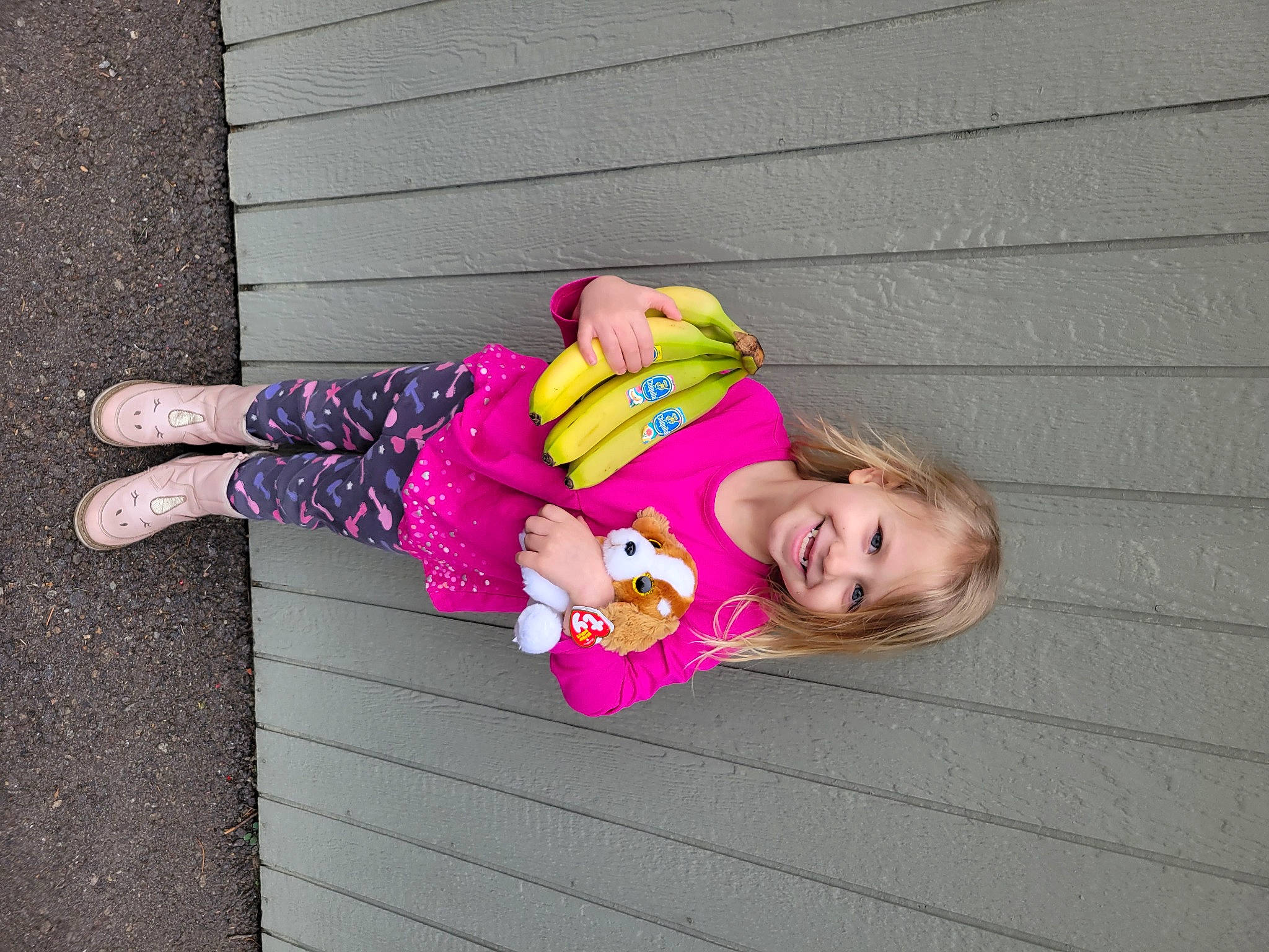 Scarlett is registered to the contest to win money with this photo: baby_toddler_clothing, child, eyewear, face, fun, happy, human_leg, joy, leisure, magenta, person, pink, plant, purple, sidewalk, sitting, smile, street_fashion, sunglasses, toddler