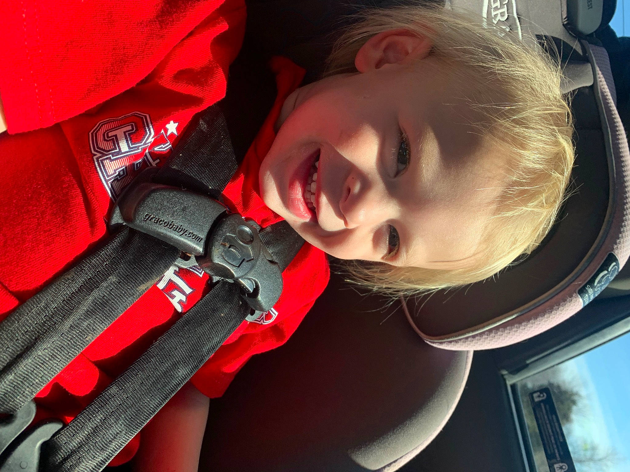 Cayden is registered to the contest to win money with this photo: auto_part, automotive_lighting, baby, baby_carriage, car_seat, carmine, child, cool, electric_blue, eyelash, finger, flash_photography, happy, joy, lip, mouth, neck, nose, person, smile