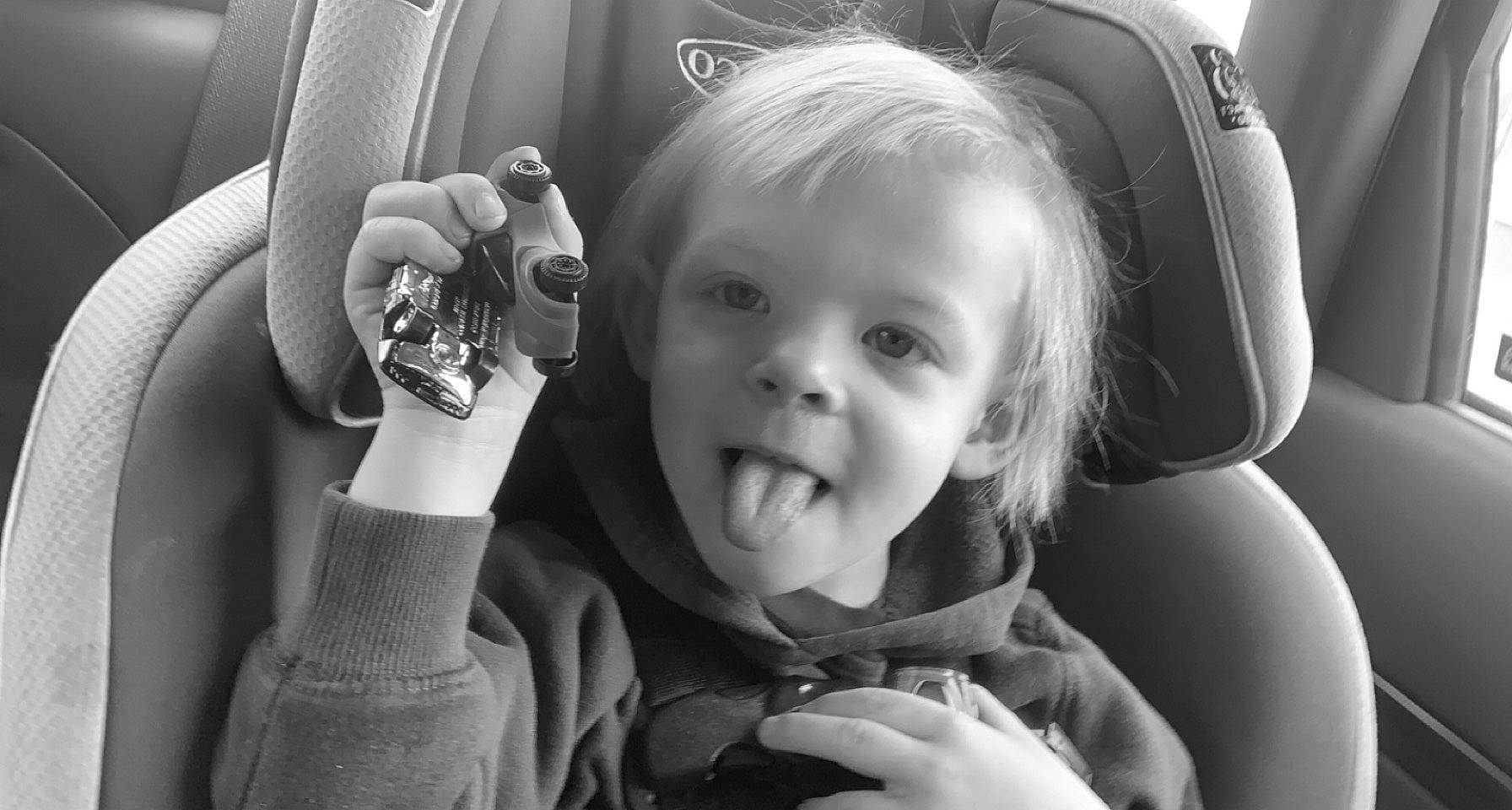 Cayden joined the competition — help win amazing prizes! arm, automotive_design, black, black_and_white, comfort, eye, face, facial_expression, finger, flash_photography, gesture, hand, happy, iris, motor_vehicle, person, photograph, skin, smile, style