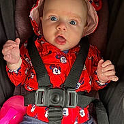 Rosalie joined the competition — help win amazing prizes! baby, child, infant, portrait, stroller, car_seat, safety_harness, red_clothing, minnie_mouse, bonnet, blue_eyes, wide_eyed, open_mouth, hands, sitting, indoors, close_up, pink_toy, fabric, happy