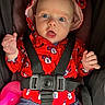 baby, child, infant, portrait, stroller, car_seat, safety_harness, red_clothing, minnie_mouse, bonnet, blue_eyes, wide_eyed, open_mouth, hands, sitting, indoors, close_up, pink_toy, fabric, happy
