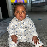 Raphael joined the competition — help win amazing prizes! baby, child, pajamas, carpet, floor, drool, indoor, face, person, sitting, clothing, cute, home, infant, looking, young_child, portrait, hands, feet, television