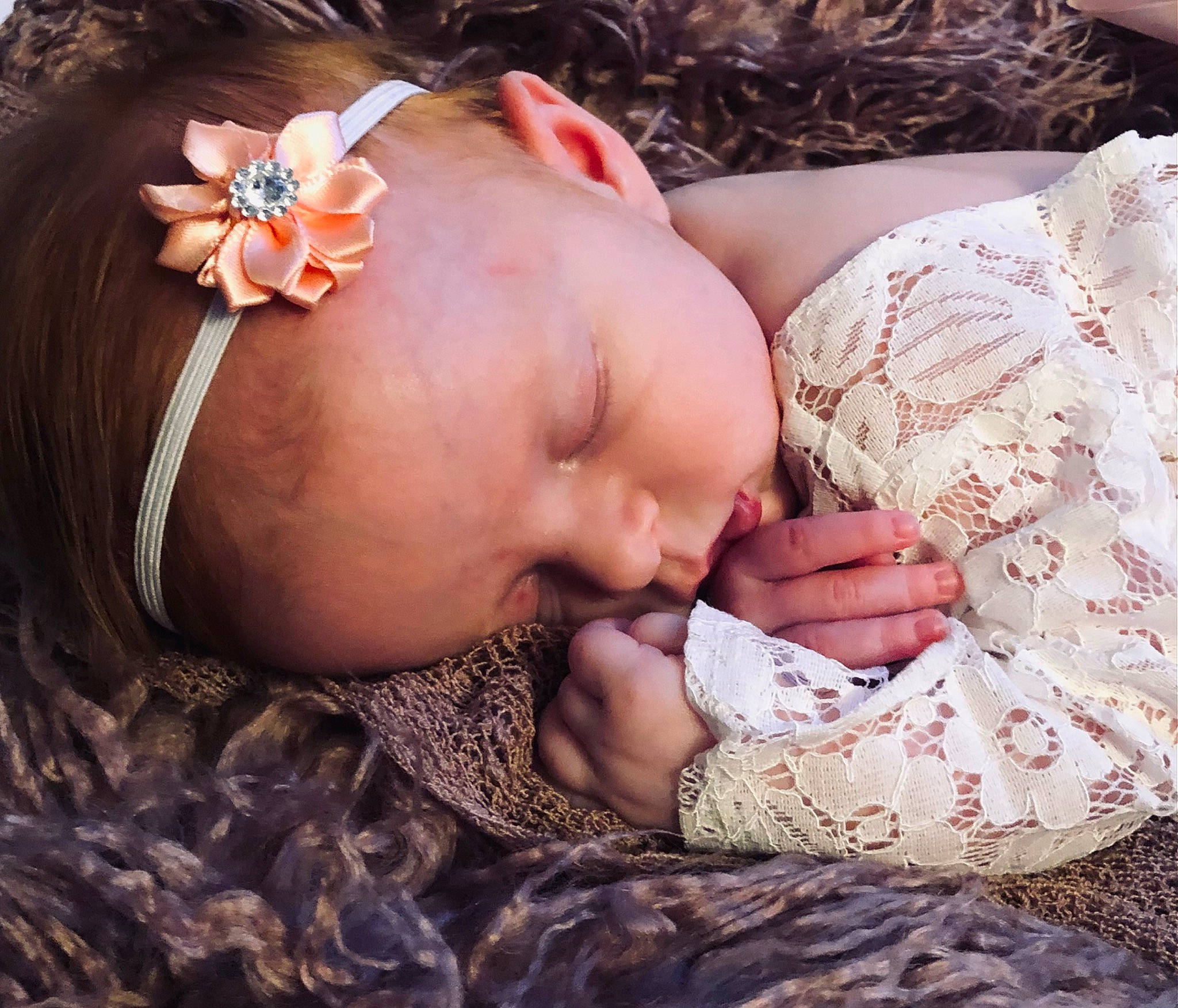 Georgie is registered to the contest to win money with this photo: arm, baby, cheek, chest, comfort, eye, eyelash, finger, grass, hand, happy, head, human_body, mouth, nail, neck, person, plant, skin, sunglasses