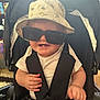 Milo-Chrisopher joined the competition — help win amazing prizes! baby, child, sunglasses, hat, bucket_hat, stroller, smile, teeth, white_shirt, striped_shorts, seatbelt, indoor, cute, happy, person, infant, hand, face, headwear, casual