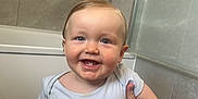 Milo-Chrisopher joined the competition — help win amazing prizes! baby, child, smile, tooth, arm, hand, bathroom, bathtub, tile, wall, person, white_clothing, happy, cute, infant, holding, head, face, skin, young