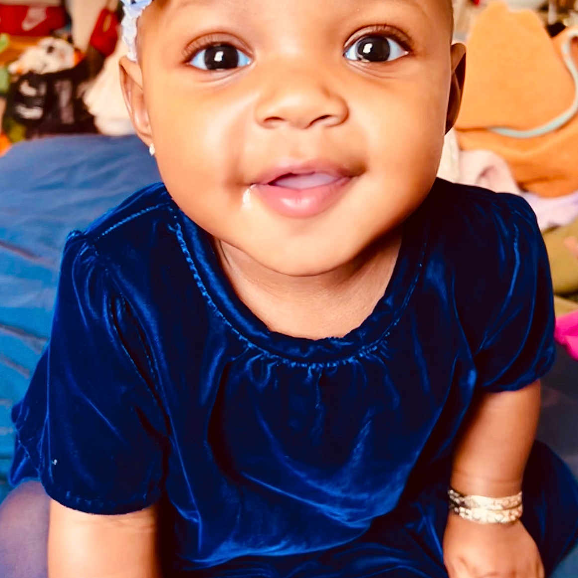 Raine Beaux is registered to the contest to win money with this photo: accessories, baby, bracelet, clothing, couch, dress, earring, face, furniture, happy, hat, head, headband, jewelry, necklace, person, photography, portrait, smile, t_shirt