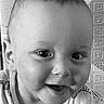 baby, background, black_and_white, child, closeup, cute, expression, eyes, face, happy, head, indoors, infant, onesie, person, portrait, skin, smiling, texture, young
