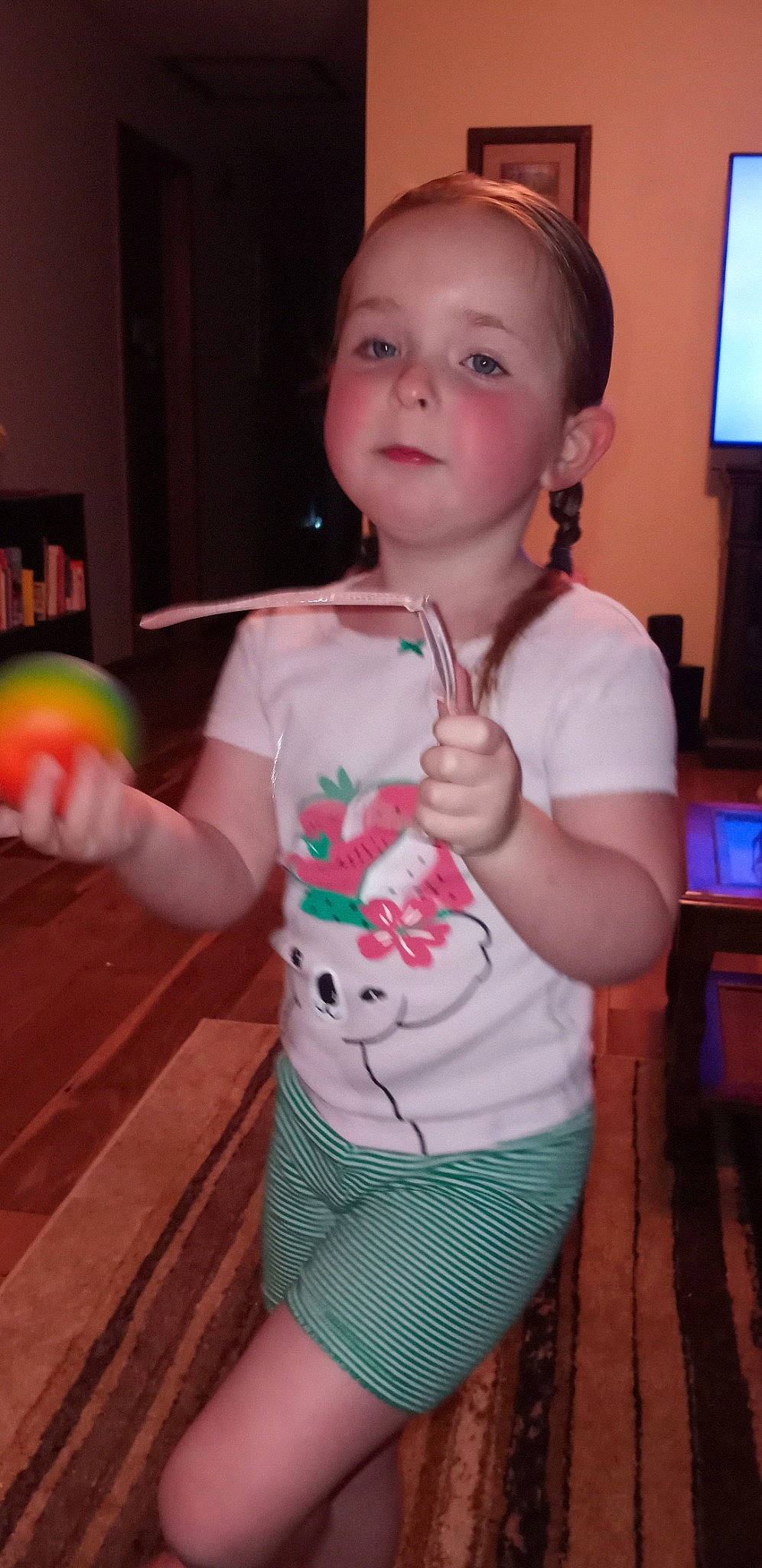 Natalee is registered to the contest to win money with this photo: arm, baby, baby_toddler_clothing, cheek, child, facial_expression, finger, fun, happy, organ, person, pink, play, shoulder, standing, t_shirt, television, thigh, thumb, toddler