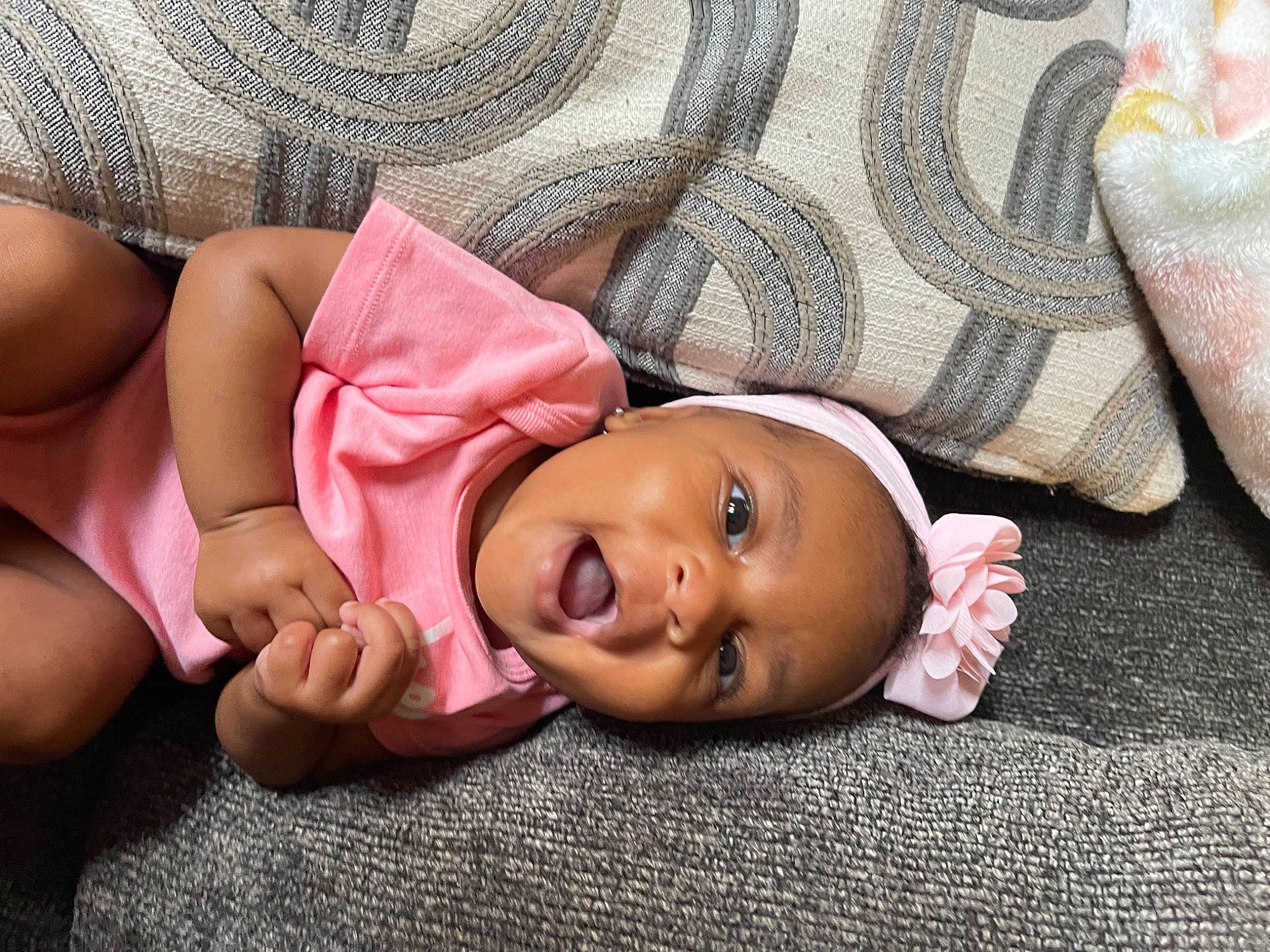 Aubrie is registered to the contest to win money with this photo: baby_toddler_clothing, cheek, child, comfort, eye, finger, gesture, grass, hand, happy, head, human_body, lip, mouth, nail, nose, person, skin, smile, toddler