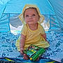 Austeja is registered to the contest to win money with this photo: baby, child, yellow_dress, sun_hat, tent, blue_tent, blanket, book, outdoor, sitting, cute, infant, portrait, curious, soft_light, playtime, summer, daylight, toys, happy