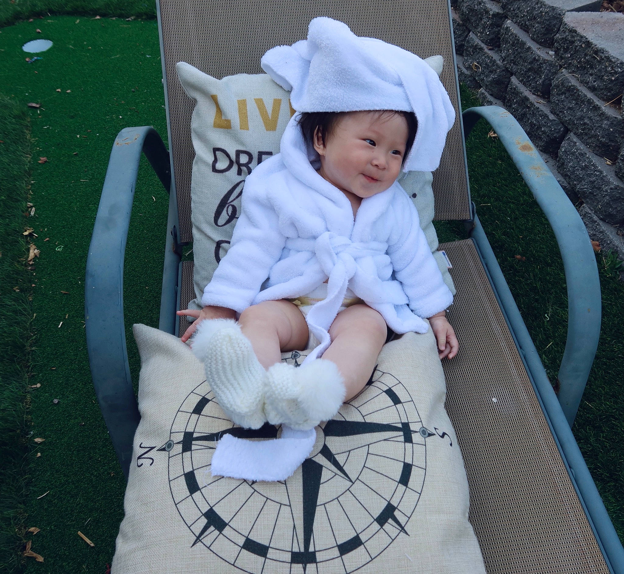 Joyce is registered to the contest to win money with this photo: baby, baby_carriage, baby_products, baby_toddler_clothing, chair, child, comfort, fashion_accessory, grass, happy, hat, headwear, lap, leisure, outdoor_furniture, pattern, person, product, sitting, smile