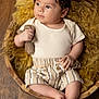 baby, infant, child, hat, striped_clothing, knitted_toy, teddy_bear, wooden_bowl, yellow_wool, curious, cute, portrait, indoors, soft_light, plush, relaxing, small_hands, barefoot, cozy, adorable