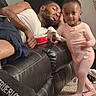 black, carpet, casual, child, couch, family, furniture, home, indoor, leather, living_room, man, pajamas, person, pink, relaxing, resting, sleeping, toddler, toy