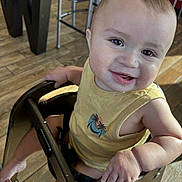 Khaza Dixon is registered to the contest to win money with this photo: baby, casual_clothing, child, cute, expression, face, foot, hand, happy, high_chair, indoor, infant, metal_chair, person, portrait, sitting, smiling, wooden_floor, yellow_tank_top, young_child