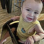 baby, casual_clothing, child, cute, expression, face, foot, hand, happy, high_chair, indoor, infant, metal_chair, person, portrait, sitting, smiling, wooden_floor, yellow_tank_top, young_child