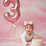 baby, girl, pink, tutu, bow, balloon, number_3, cake, birthday, celebration, confetti, white_top, headband, smiling, cute, portrait, studio, floor, infant, happy
