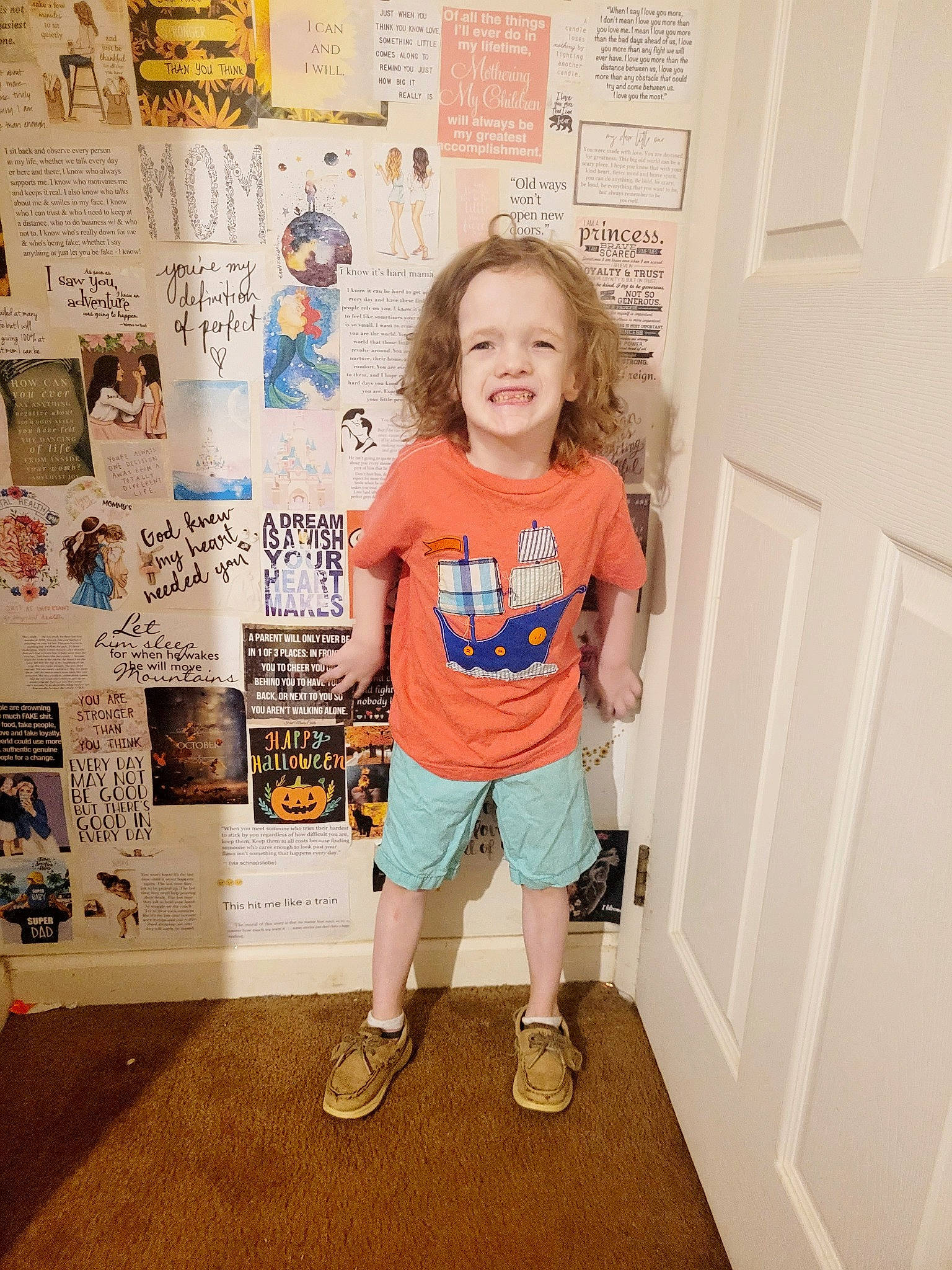 Ryker is registered to the contest to win money with this photo: baby_toddler_clothing, bermuda_shorts, child, door, electric_blue, fashion_design, flooring, happy, human_leg, joy, knee, pattern, person, room, shorts, sleeve, smile, sportswear, standing, t_shirt