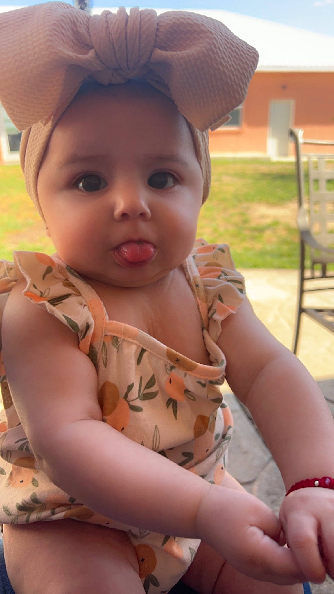 Leilani is registered to the contest to win money with this photo: arm, baby, baby_toddler_clothing, cap, face, finger, fun, hairstyle, hand, happy, headgear, human_body, lip, mouth, nose, organ, person, pink, skin, summer